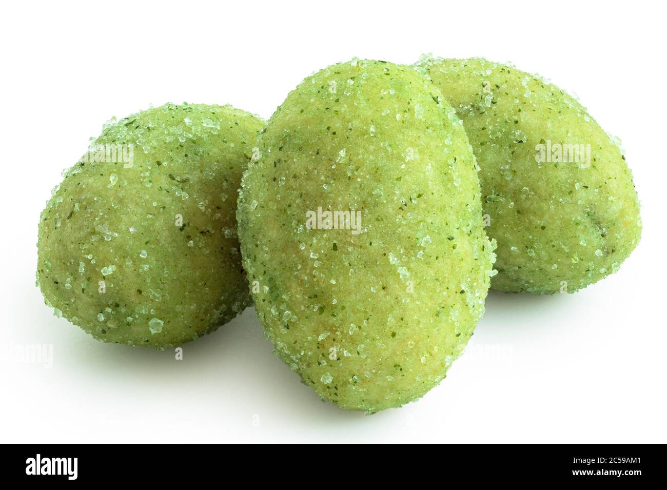 Three wasabi coated peanuts isolated on white. Stock Photo