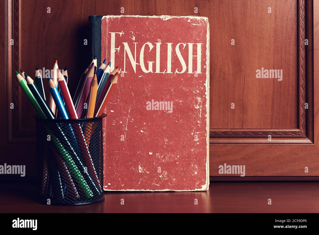 English dictionary with pencils on a wooden table. Learning language Stock Photo
