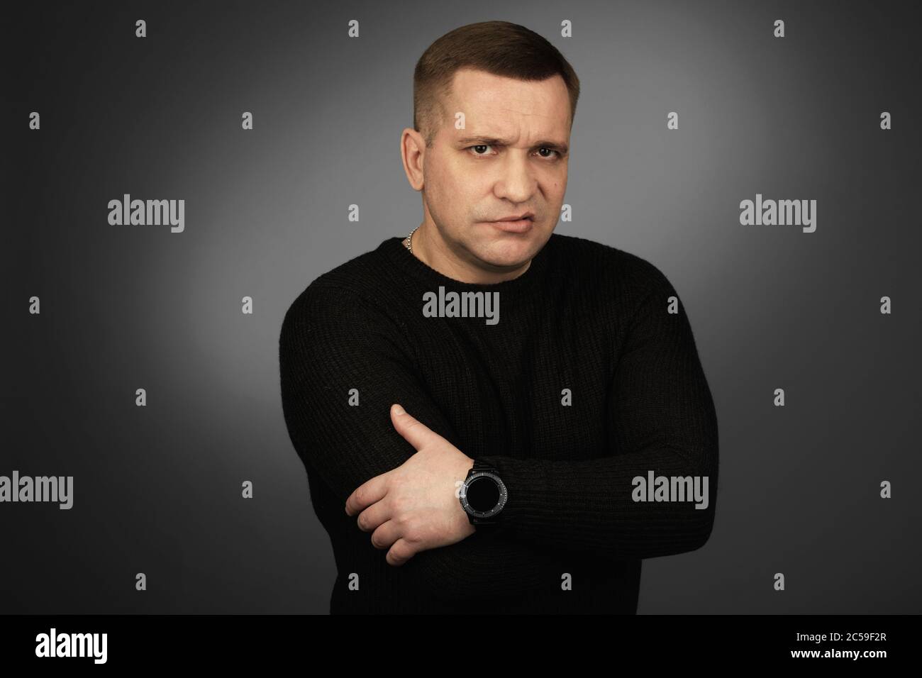 middle aged guy with disgust emotion on his face. Studio shot over grey background Stock Photo