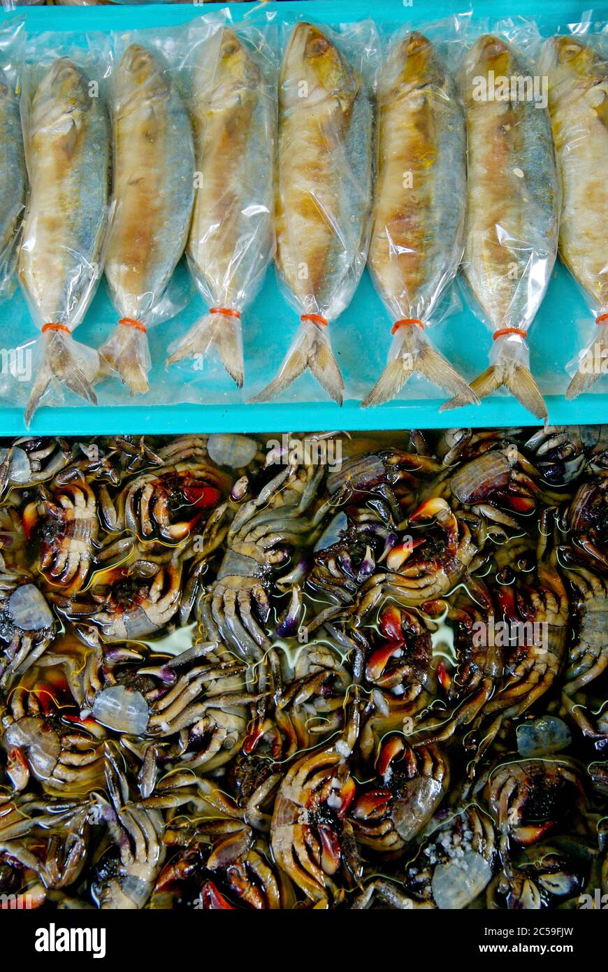 Thailand, Bangkok, display of packaged fried fish and macerated crab Stock Photo Alamy
