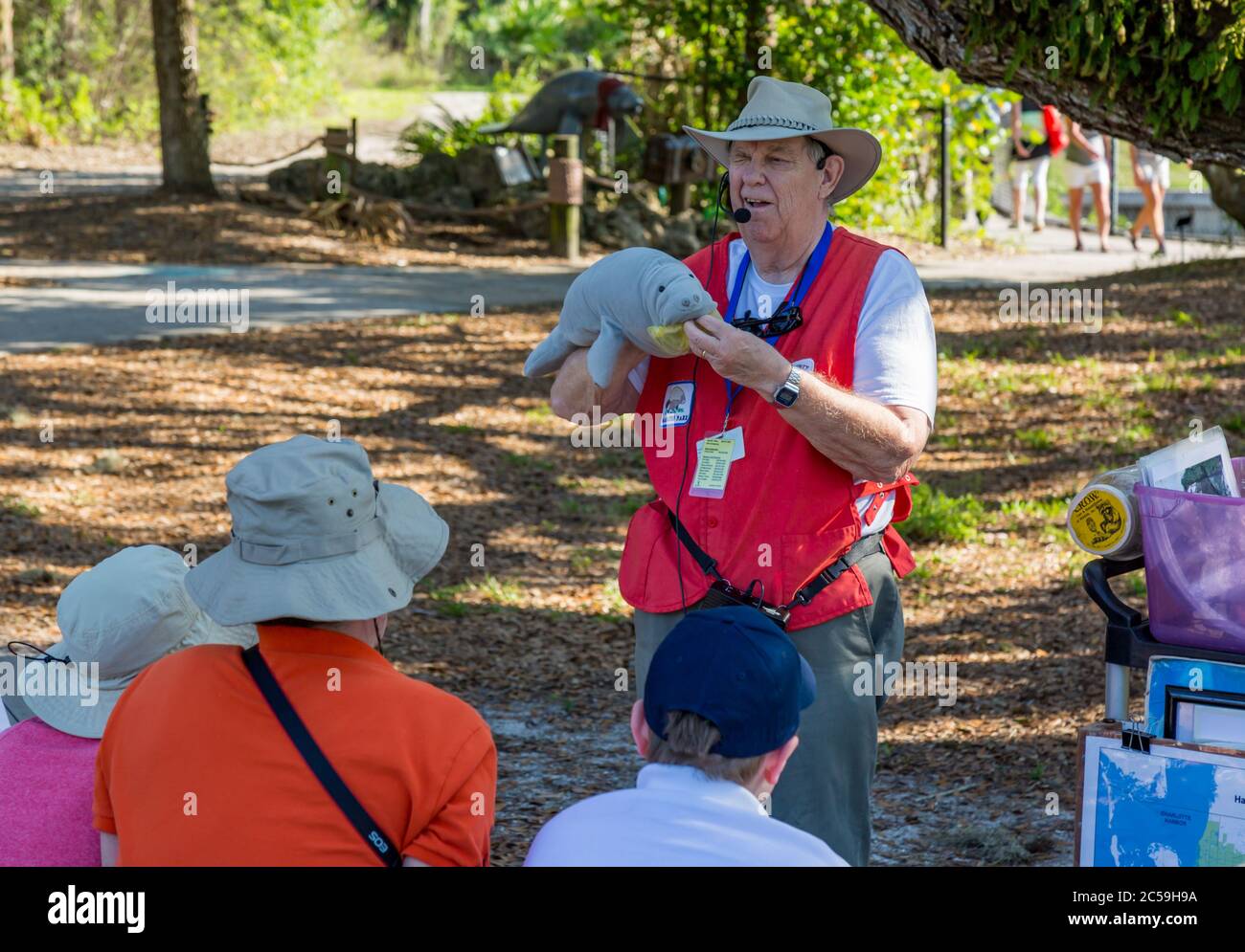 An instructor teaches park visitors about the hazards of plastic bag pollution to manatees in a program at Manatee Park in Fort Myers, Florida, USA Stock Photo