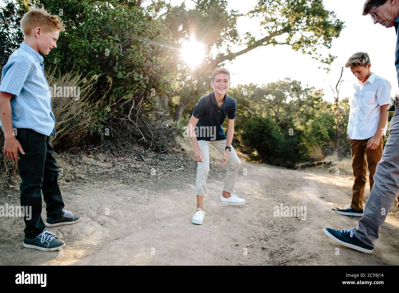 A Boy Rolls Up His Pant Leg On His Khakis And Laughs Stock Photo Alamy
