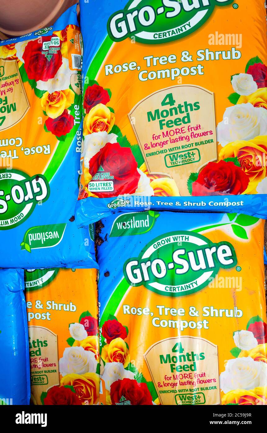 A stack of Grow Sure Rose Tree and Shrub Growing Compost in a garden centre Stock Photo Alamy