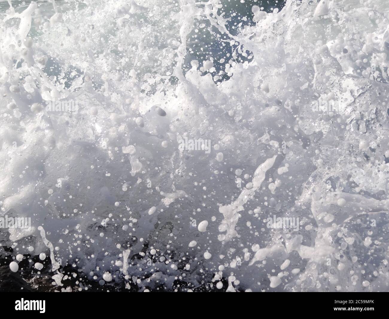 A splash of sea wave on the beach, close up details Stock Photo