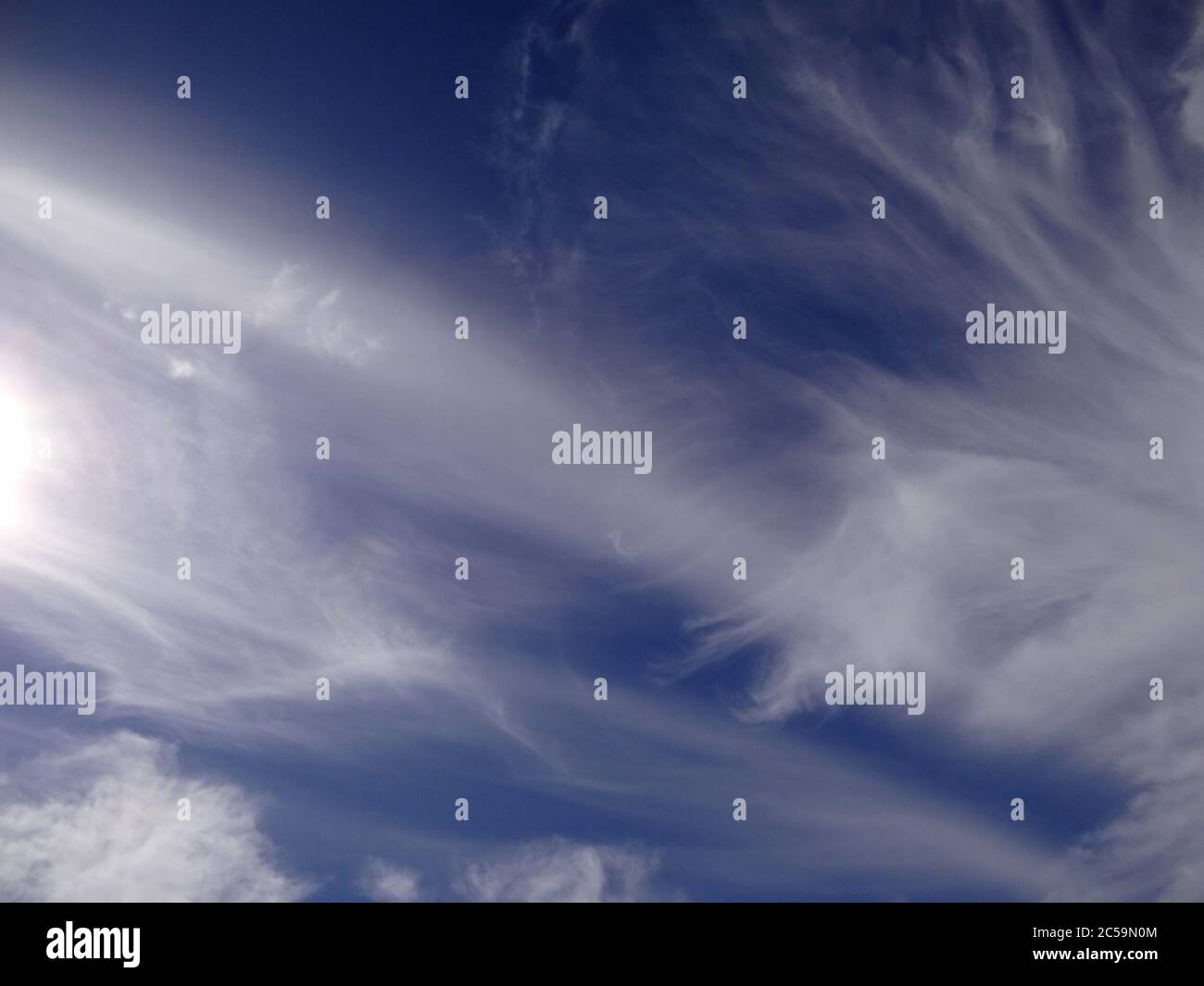 Beautiful strange clouds on blue sky background texture Stock Photo