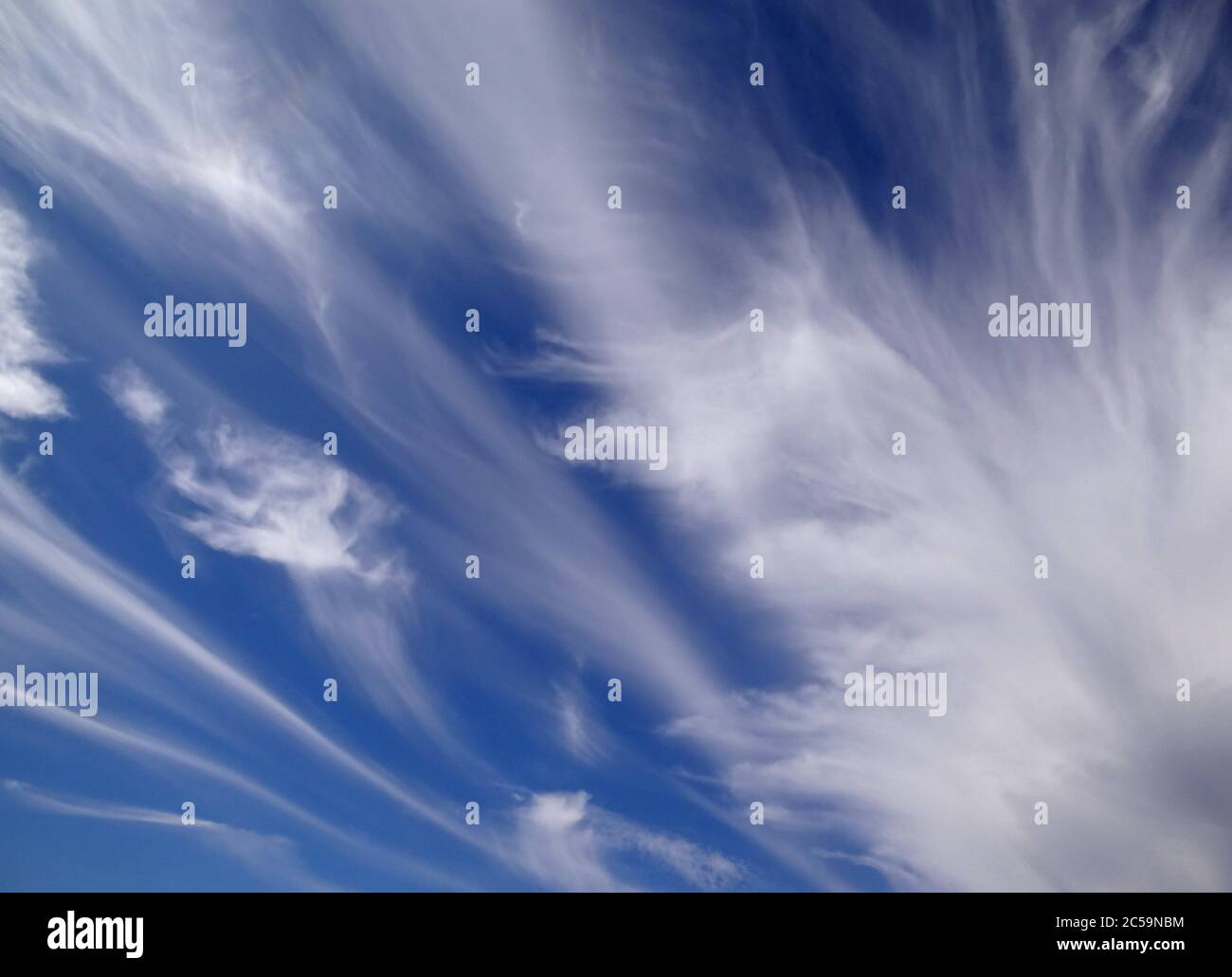 Beautiful strange clouds on blue sky background texture Stock Photo