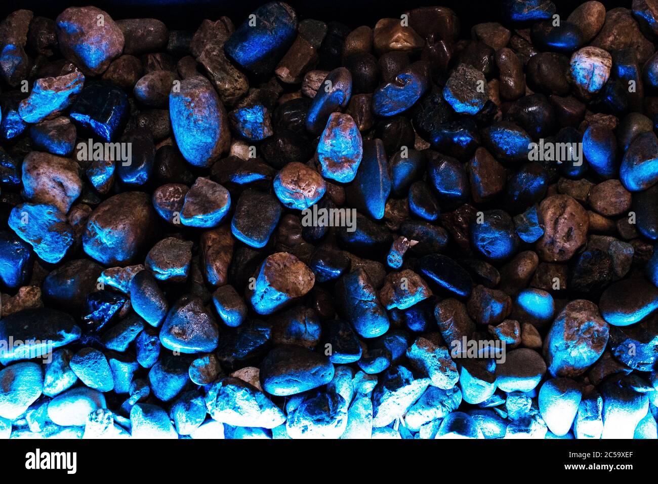 Small decorative stones with blue backlight in dark colors Stock Photo
