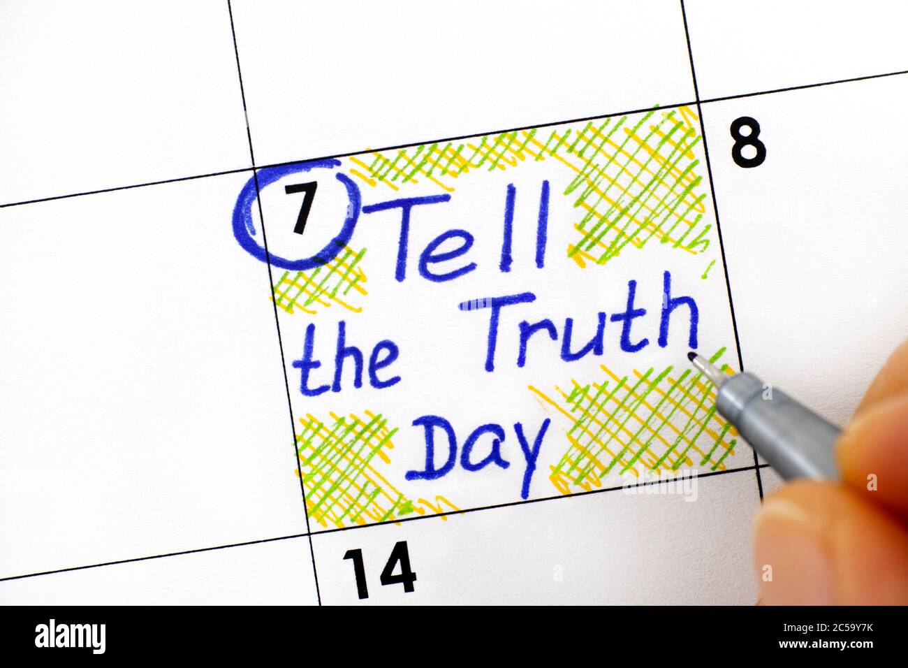 Woman fingers with pen writing reminder Tell the Truth Day in calendar. July 07. Stock Photo