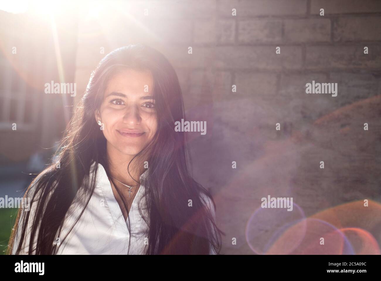 Portrait of a beautiful young girl, Indian nationality. On the background of the wall texture. Outdoors Stock Photo