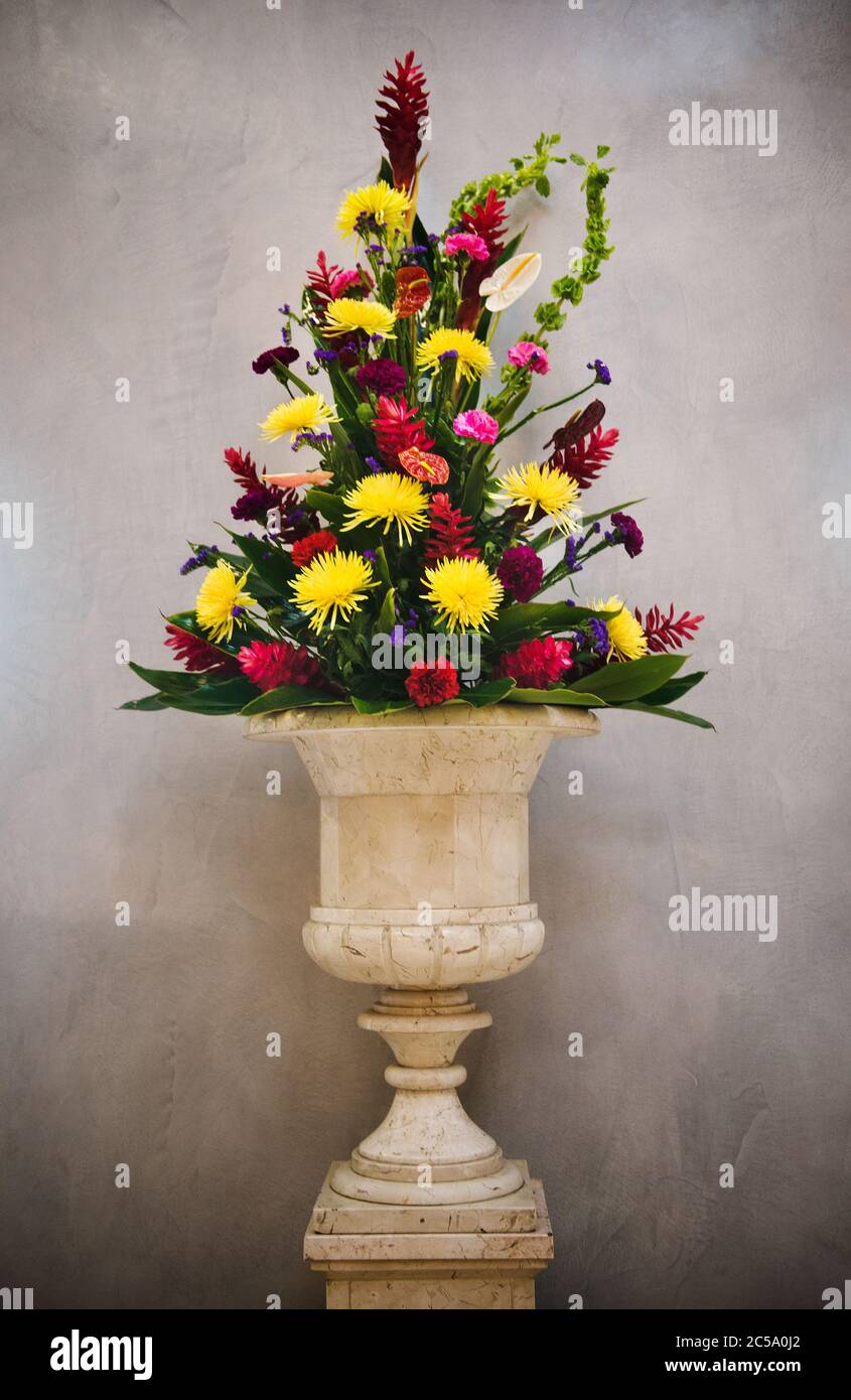 Large bouquet of flowers in a vase on cement background Stock Photo
