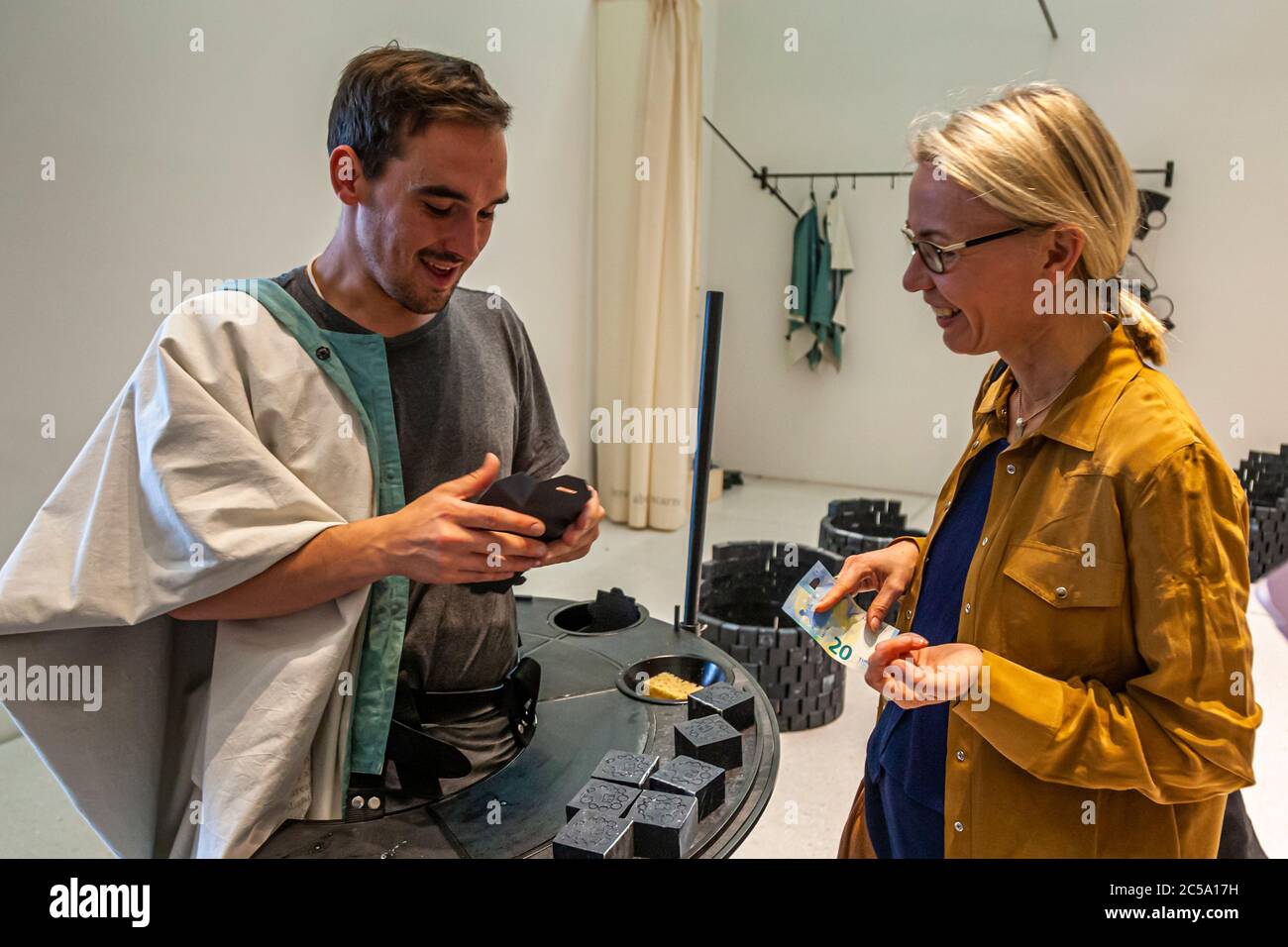 In the middle of the sales talk: Pleasure factor author Angela Berg asks art student Viktor about the 7 oils in the soap by artist Otobong Nkanga. Documenta Impressions in Kassel, Germany Stock Photo