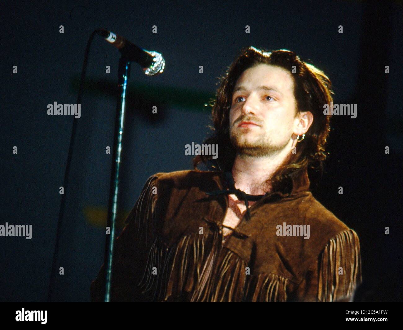 U2 performing at the Self Aid concert in aid of unemployement in Ireland at the RDS Anglesea Stand,Ballsbridge,Dublin,Ireland 17th May 1986: Bono Stock Photo