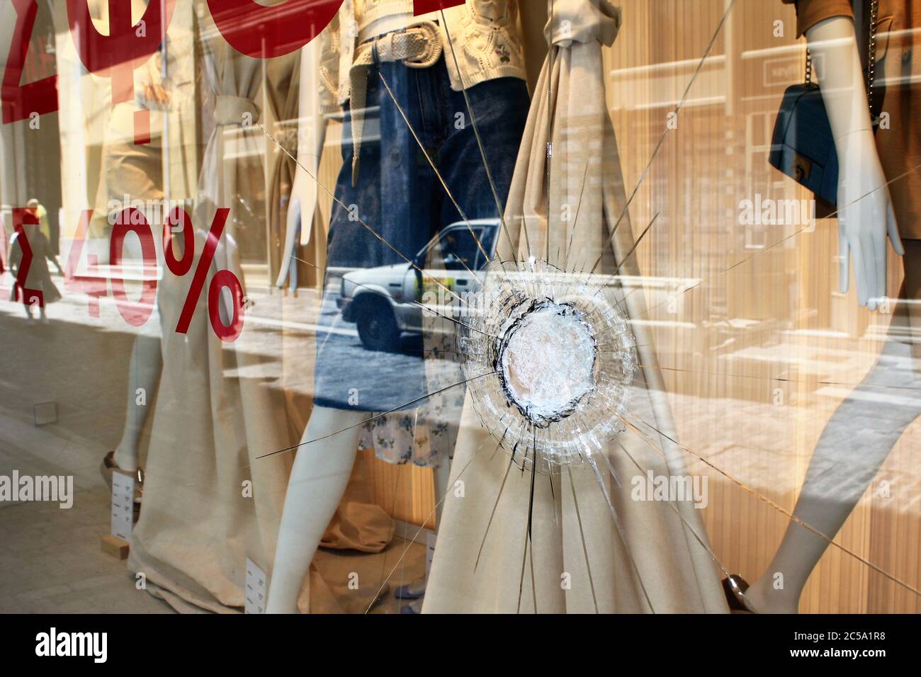 Greece, Athens, June 28 2020 - Broken glass of store window at Ermou street, in the commercial center of Athens, after vandalism made by anarchists. Stock Photo