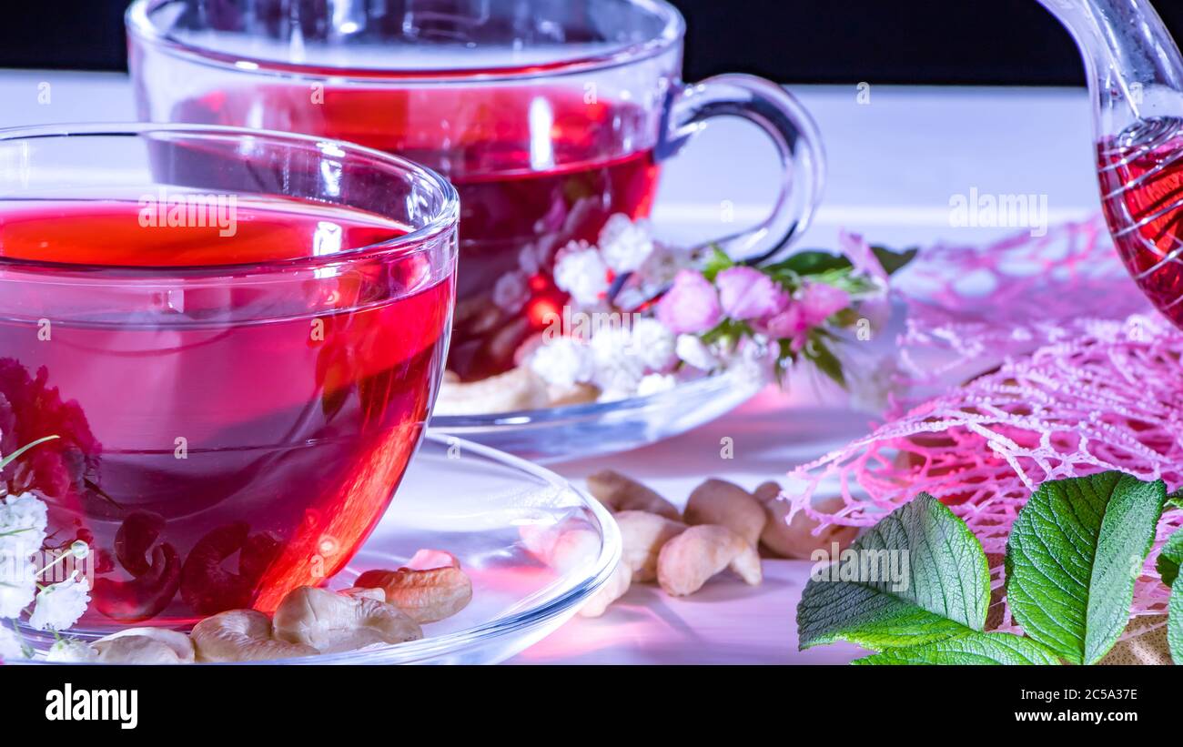 Red hot hibiscus tea in glass mug. Tea time: cup of tea, carcade, karkade, rooibos. Oriental, cozy, ceremony, tradition, japanese, leafy, hygge, autum Stock Photo