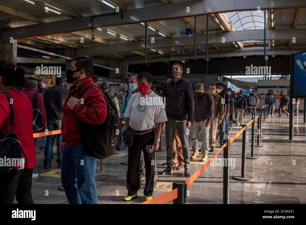 Mexiko Stadt, Mexico. 01st July, 2020. People wearing face masks are queuing in a subway station in the middle of the corona pandemic. Commuters now have to wear a mask, their hands are sprayed with disinfectant before using transport. The Mexican government has confirmed 226,089 Covid-19 infected and 27,769 coronavirus deaths. Credit: Jacky Muniello/dpa/Alamy Live News Stock Photo