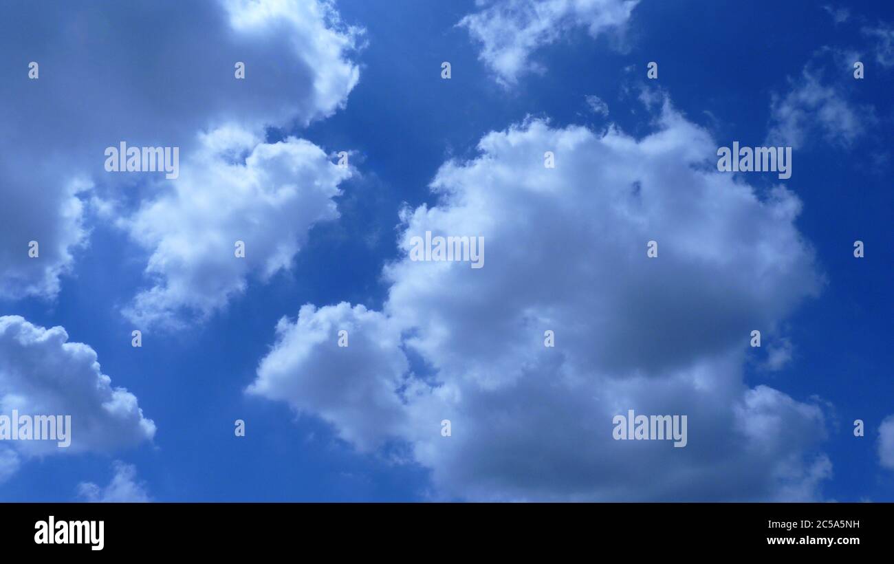 Low angle shot of fluffy clouds in the blue sky under the sunlight ...