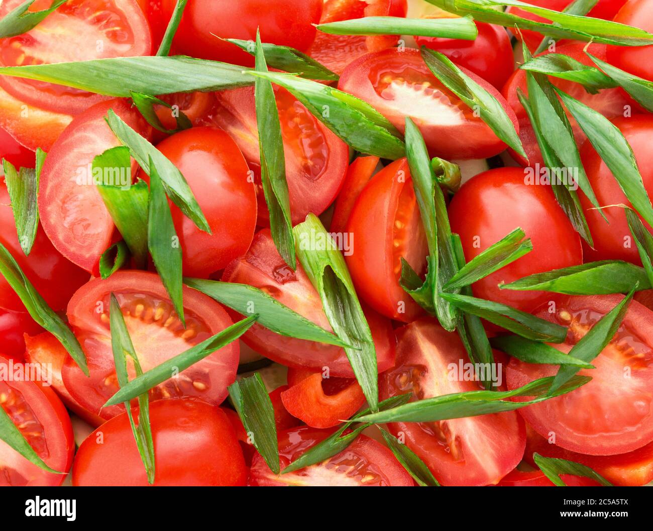 Tomato, green onion, cucumber, pepper slices. Natural background with slices of tomato, green onion. Fresh vegetable salad. Stock Photo