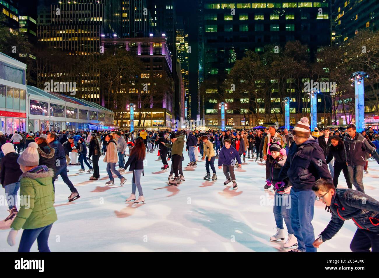 Large number of people skating on the Winter Village ice rink at Bryant Park, Manhattan, New York City, USA Stock Photo
