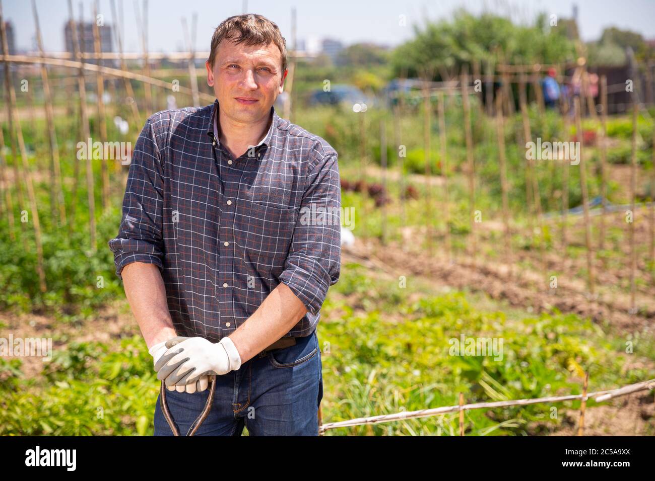 Portrait of adult farmer with shovel on his field Stock Photo - Alamy