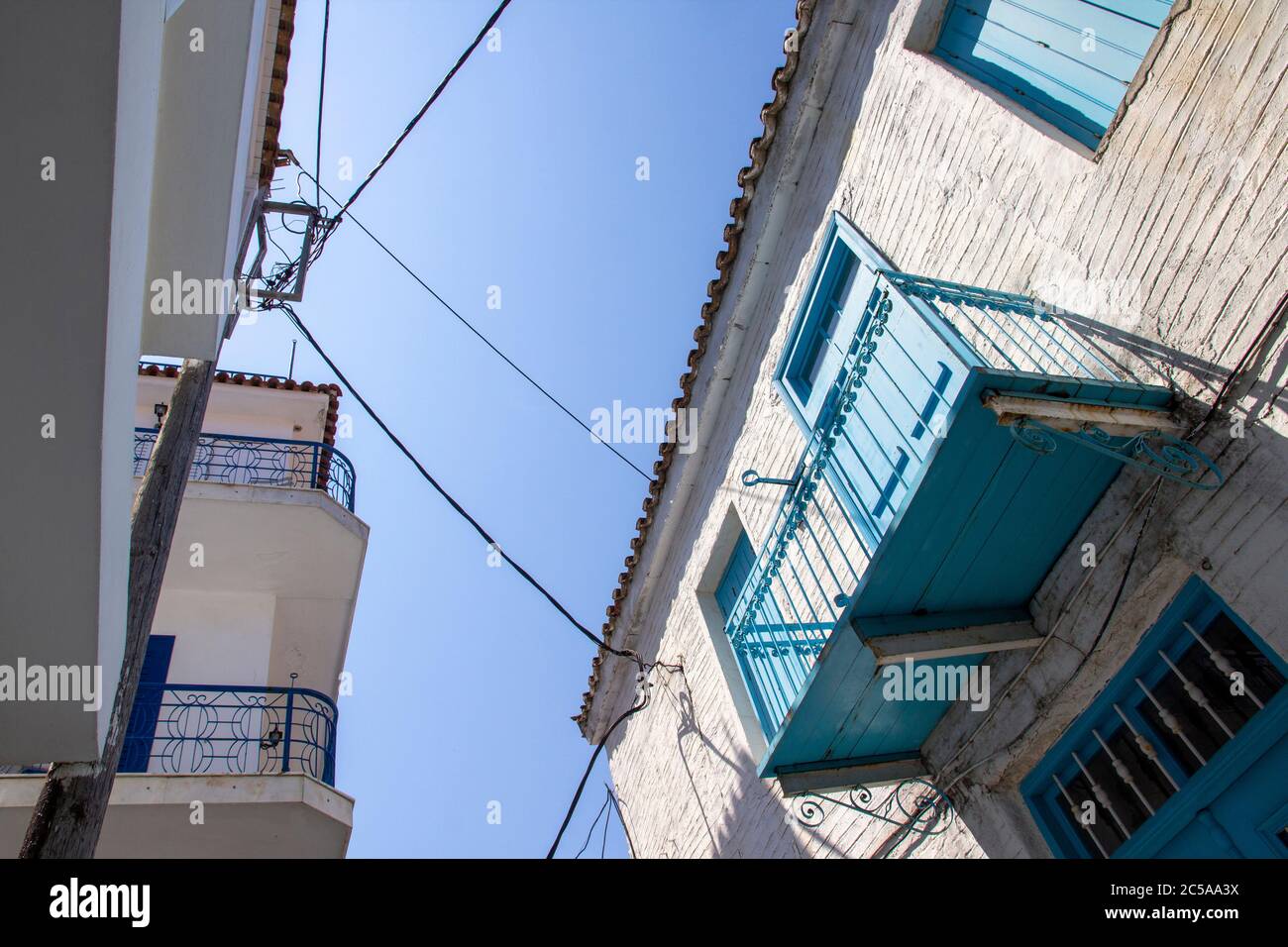 SKIATHOS, GREECE - AUGUST 13, 2019. Looking up at balcony on traditional house, Skiathos Town, Greece, August 13, 2019. Stock Photo