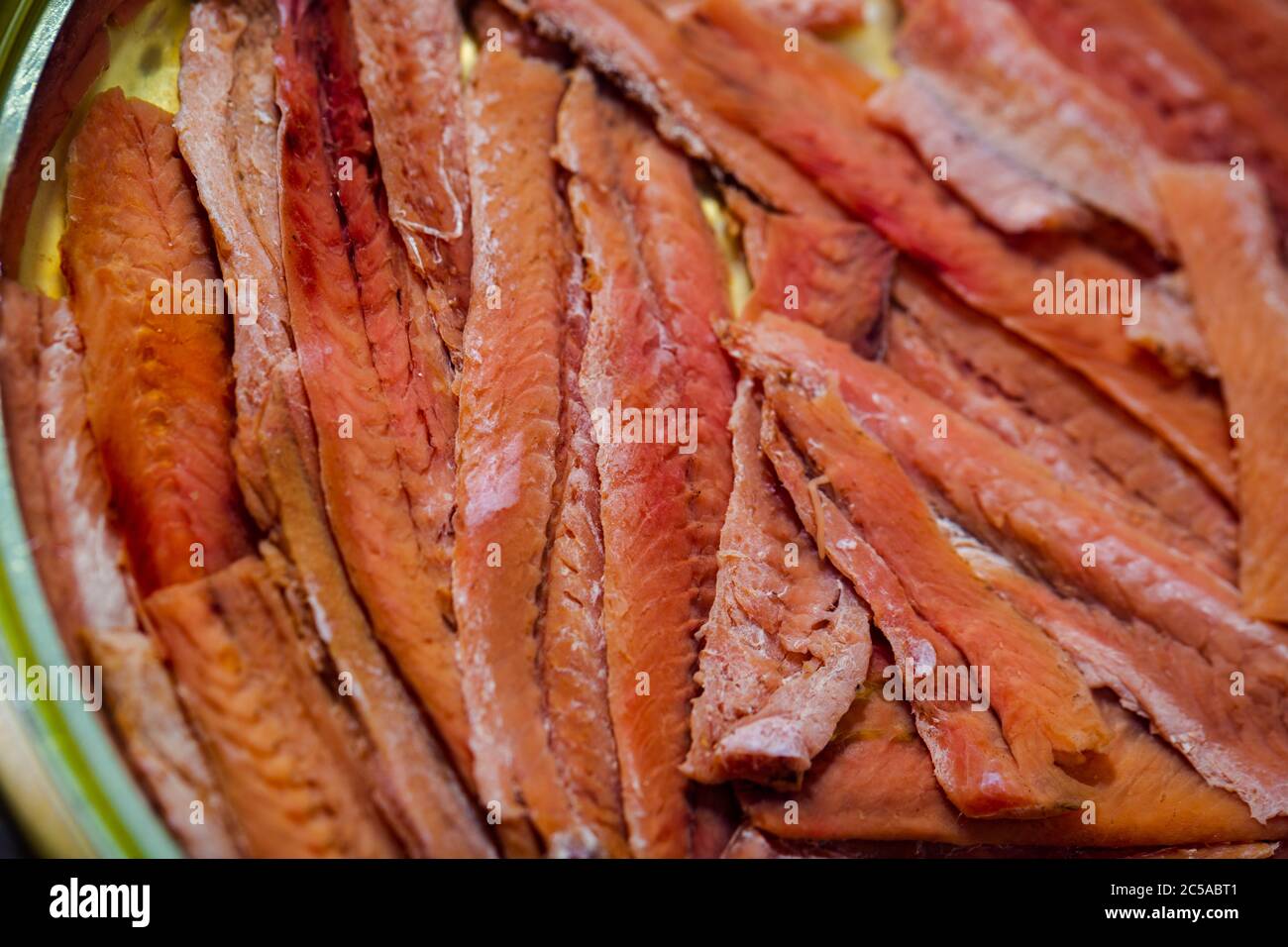 Salted anchovy fillets in oil, closeup of traditional spanish canned