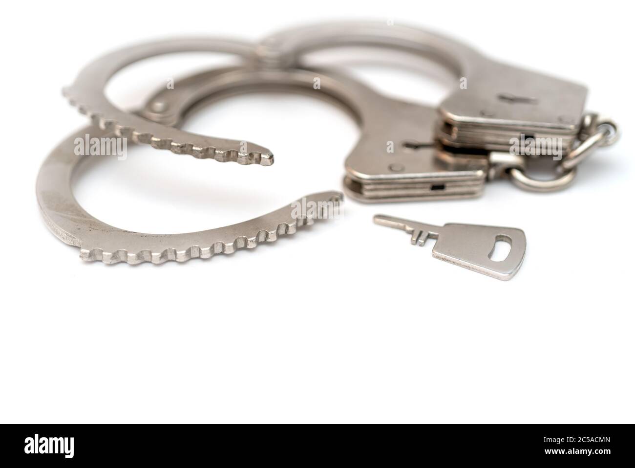 Metal handcuffs. Detention of criminals breaking  law. Restriction of freedom. Stock Photo
