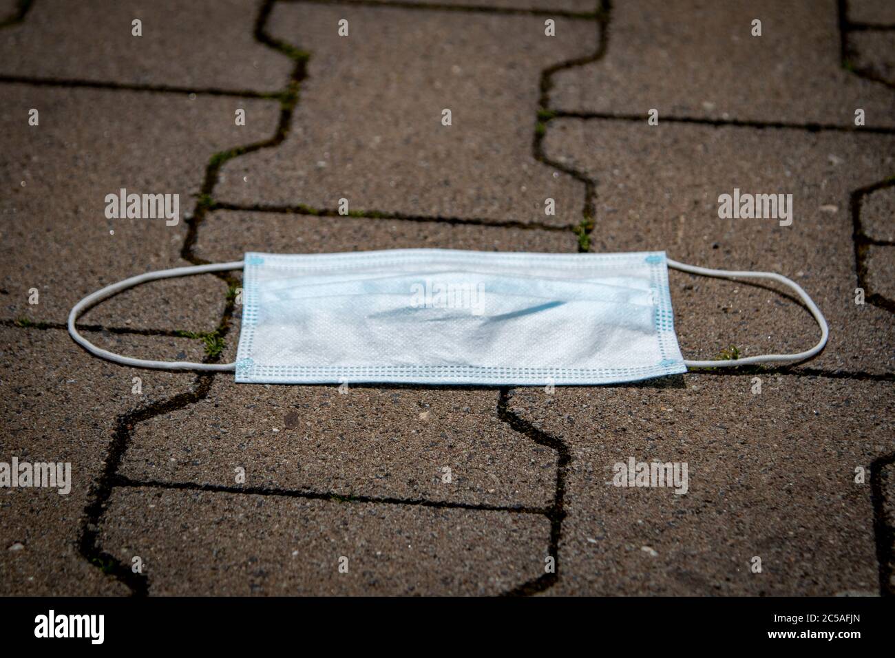 thrown away or lost mouth masks on the ground, outdoor Stock Photo Alamy