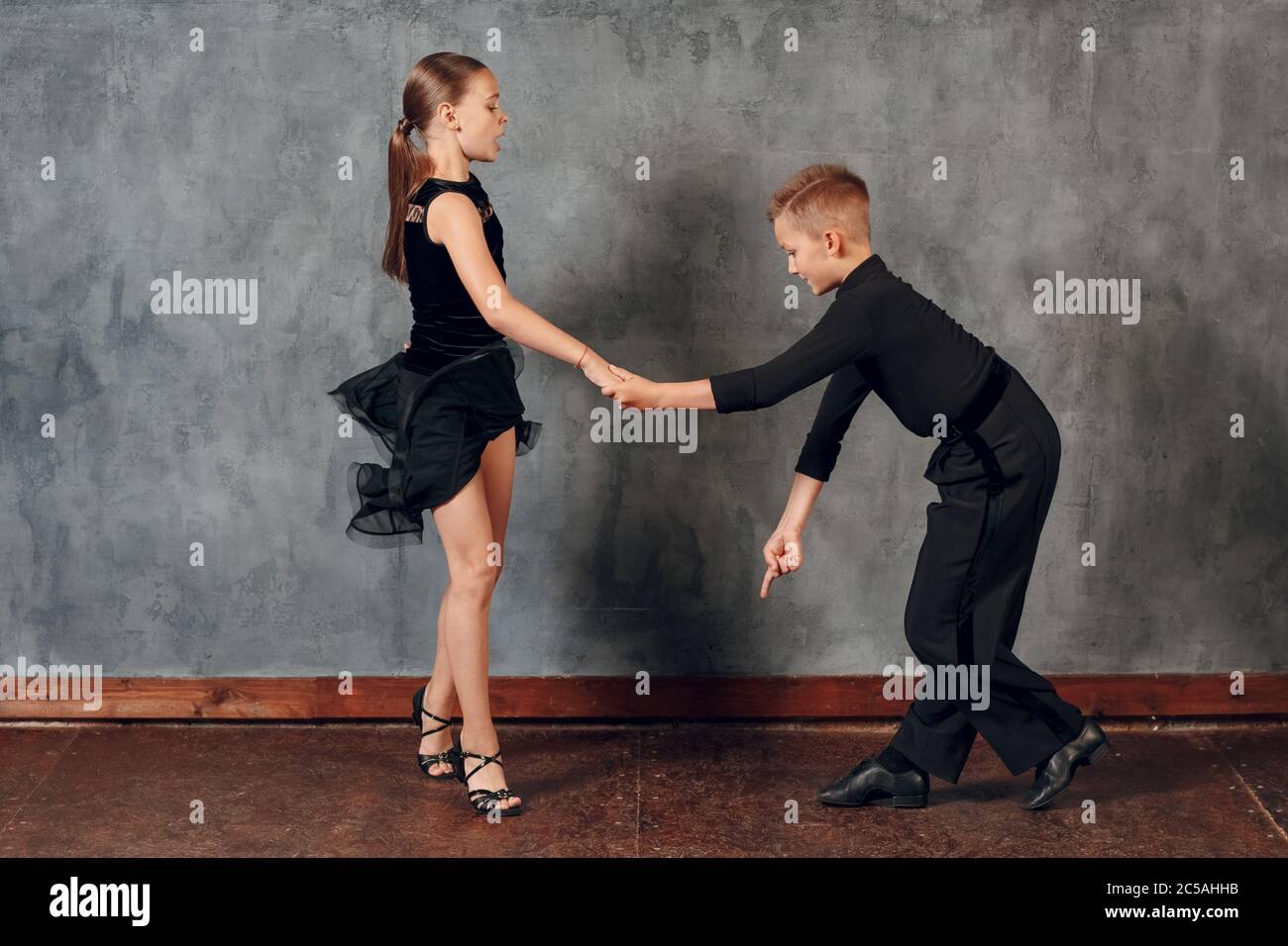 Young boy and girl dancing ballroom dance Jive. Stock Photo