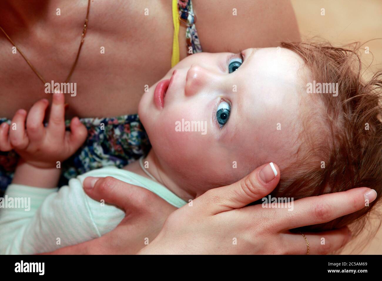 Mother calms his baby daughter Stock Photo