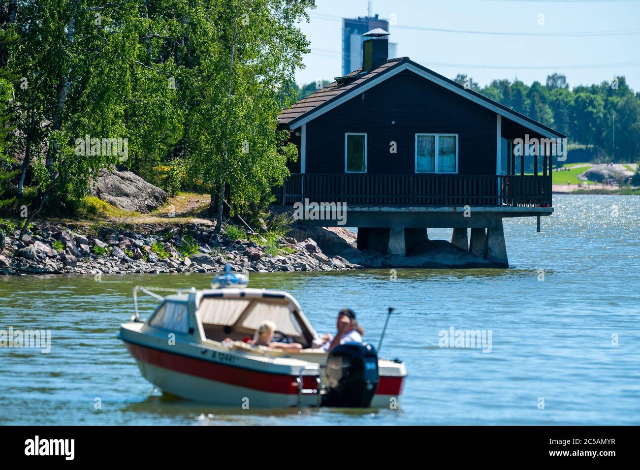 Helsinki / Finland - JUNE 21, 2020: An old wooden Finnish sauna building standing on top of the water. Stock Photo