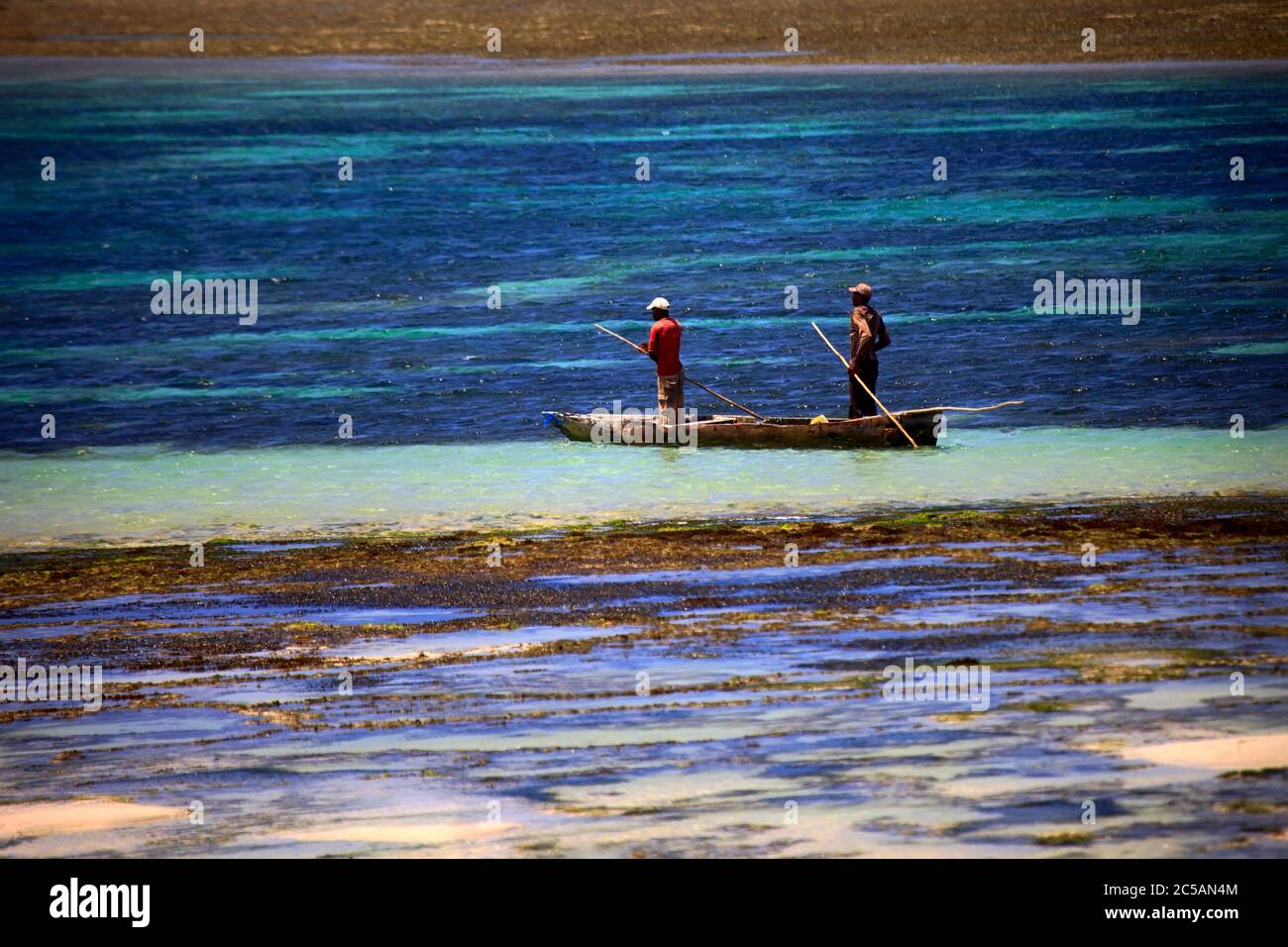 Ukunda, Kenia - January 04 2017: two fishermen in a fishing boat in shallow water. Kenya coast Stock Photo