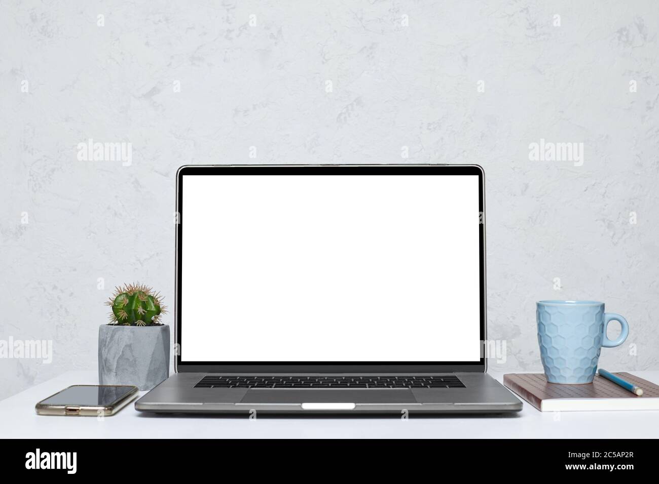 Laptop with blank empty screen on white table in interior. mockup Stock Photo