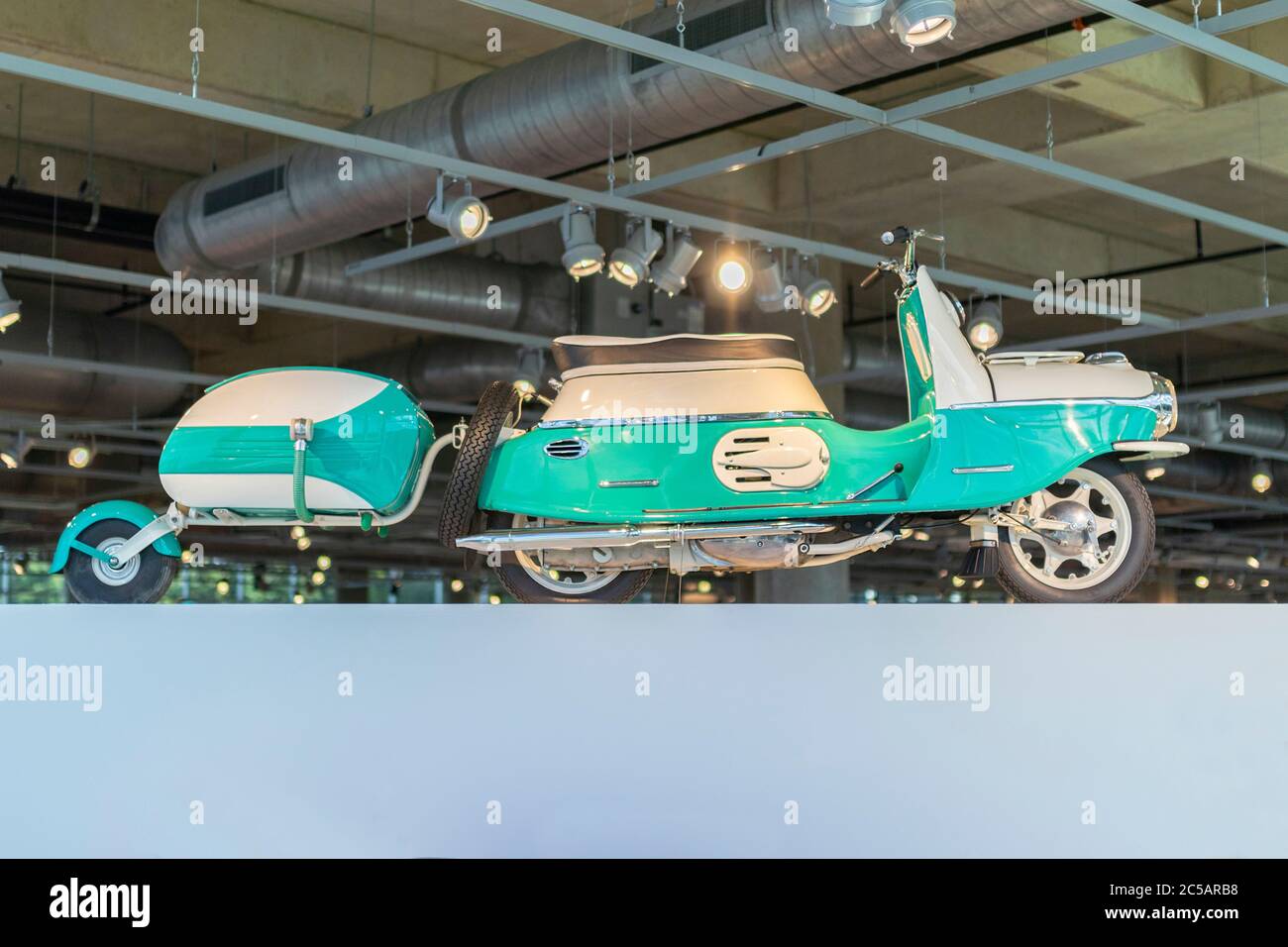 panorama of vintage green 1959 CZ Cezeta  scooter and trailer in the Barber Vintage Motorsports Museum Leeds Alabama USA USA Stock Photo