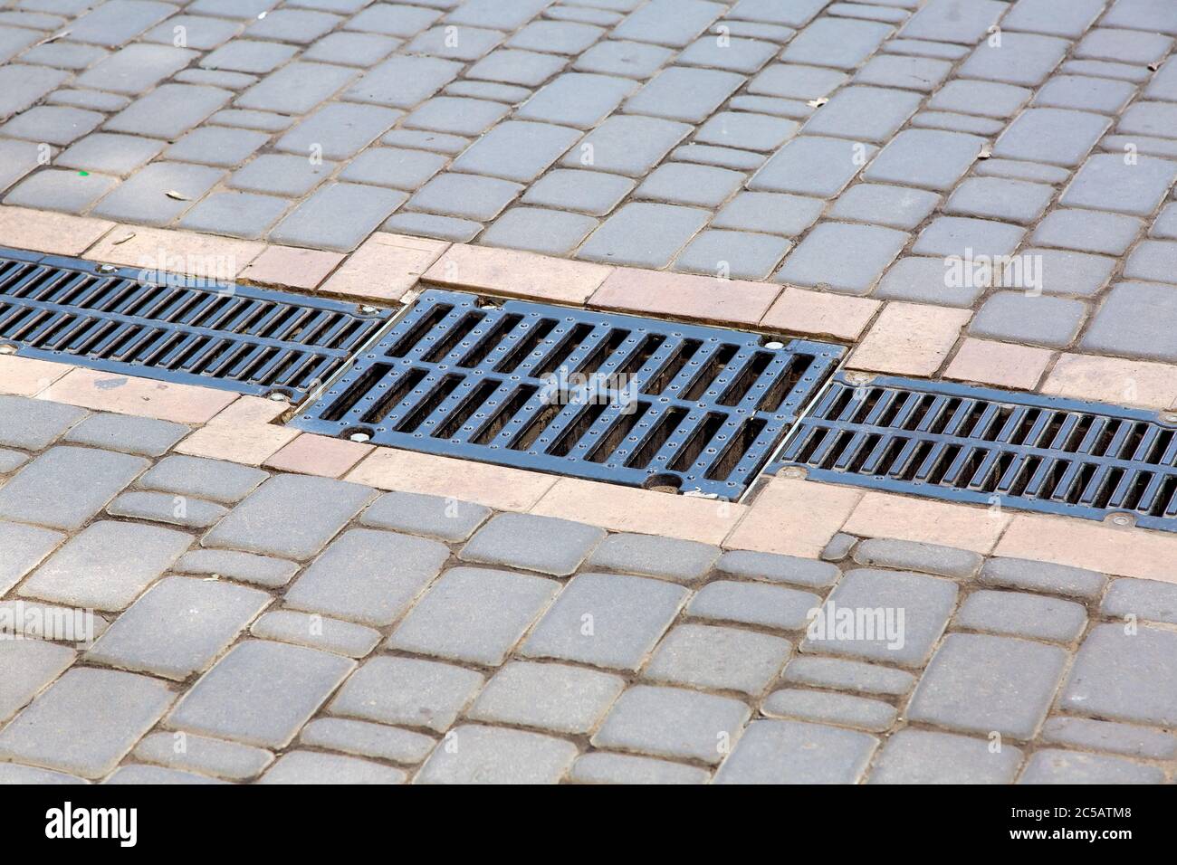 A lattice of a drainage paving system on a path made of square stone ...