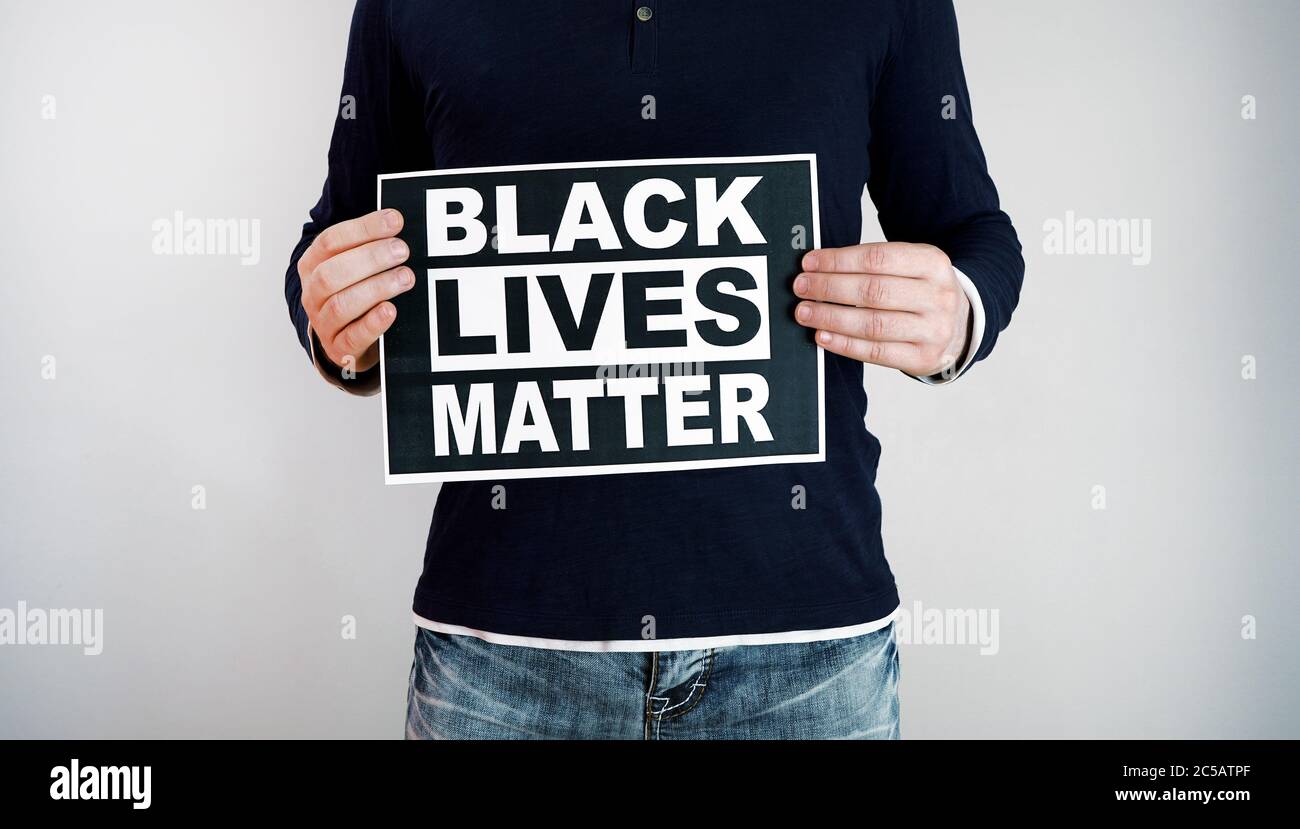 Man holding 'Black lives matter' sign. Stock Photo