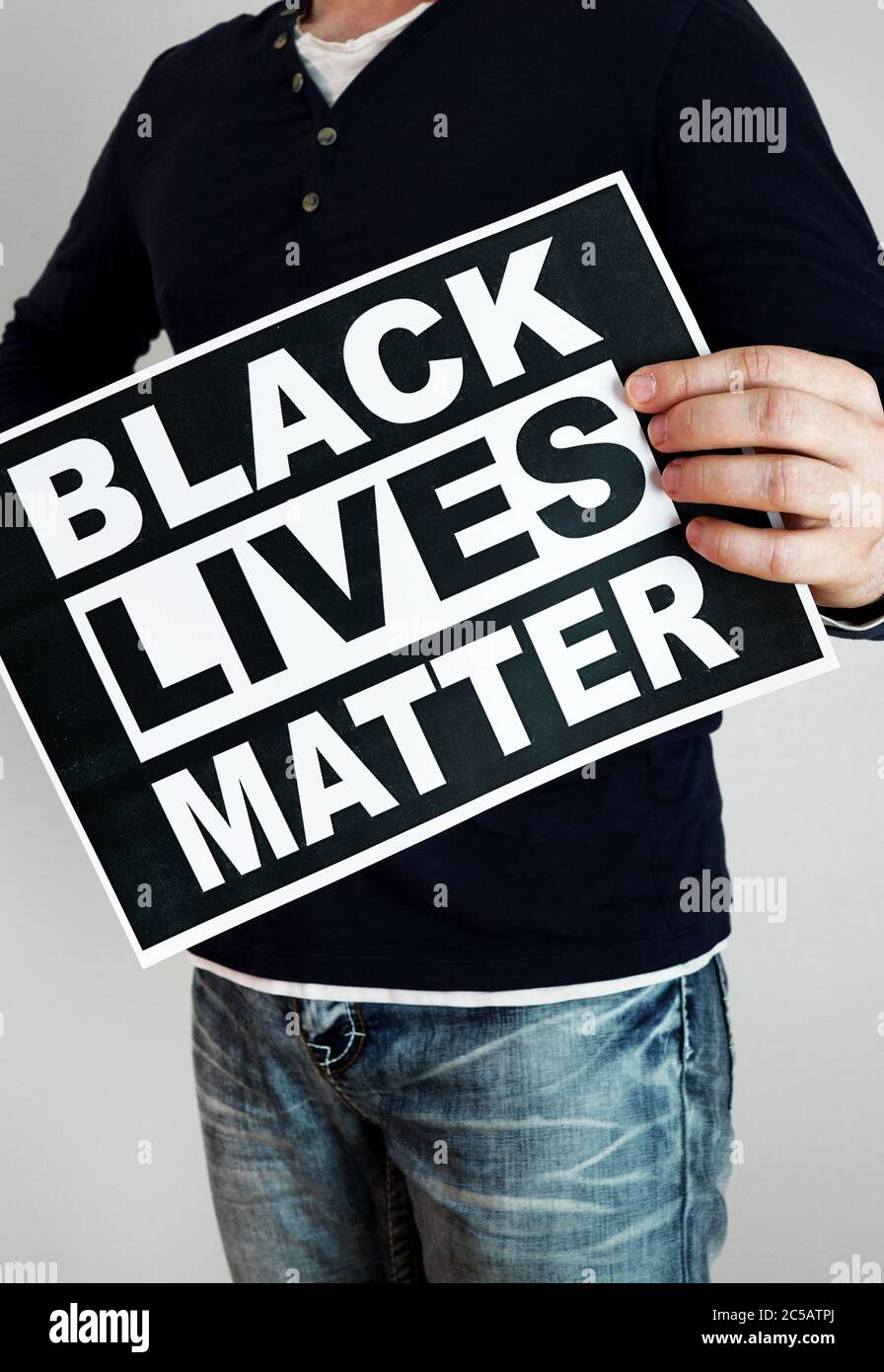 Man holding 'Black lives matter' sign. Stock Photo