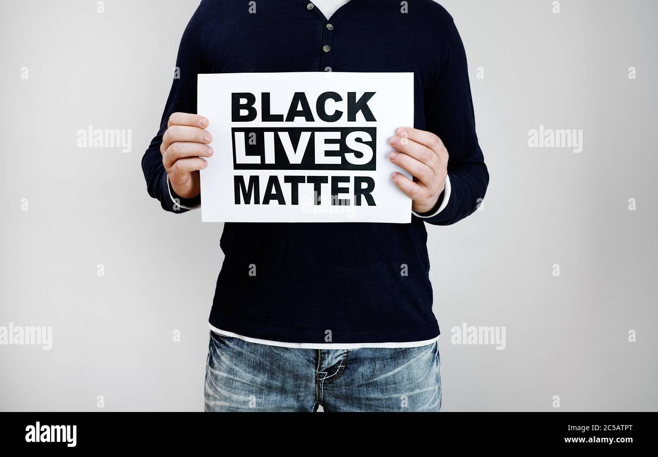 Man holding 'Black lives matter' sign. Stock Photo