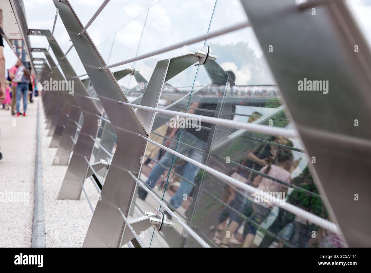 glass bridge with tension steel cables and steel railing supports with ...