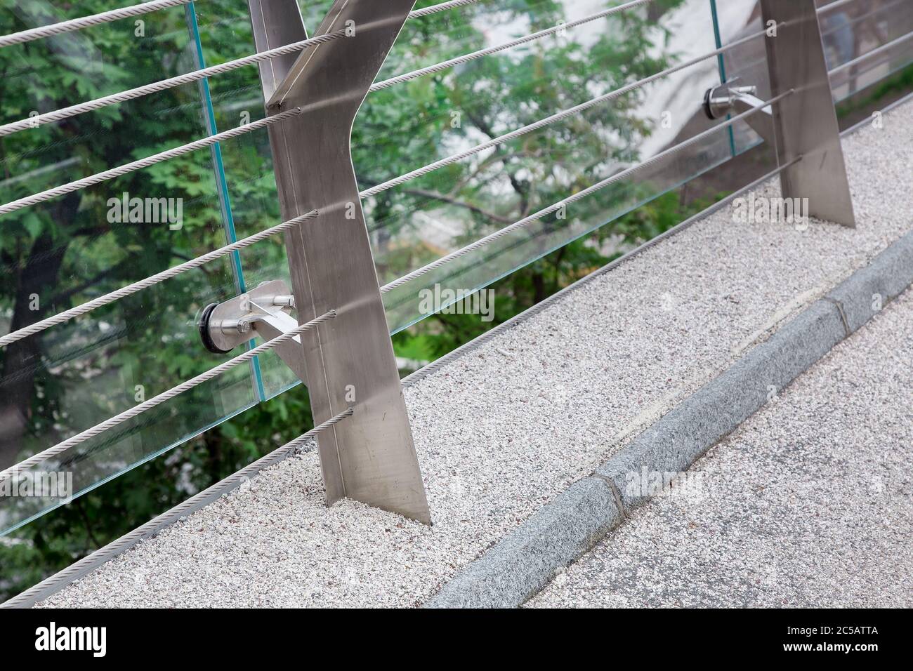 construction details of a glass bridge with steel mounts and a granite
