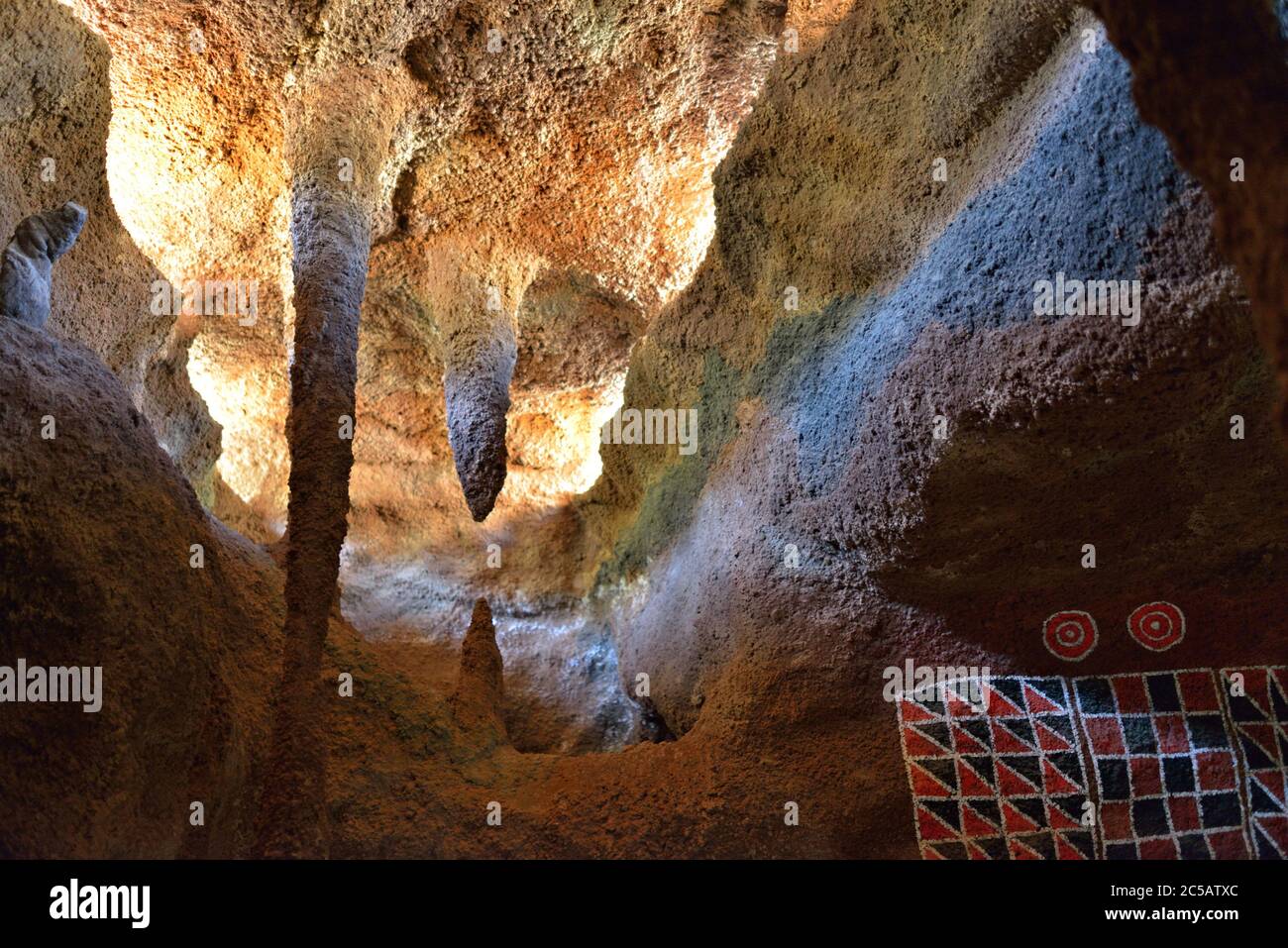 Cave habitat of natives guanche of Canary island.  Pintaderas Canarias is symbol by excellence used guanche for body and home decoration. Public archa Stock Photo