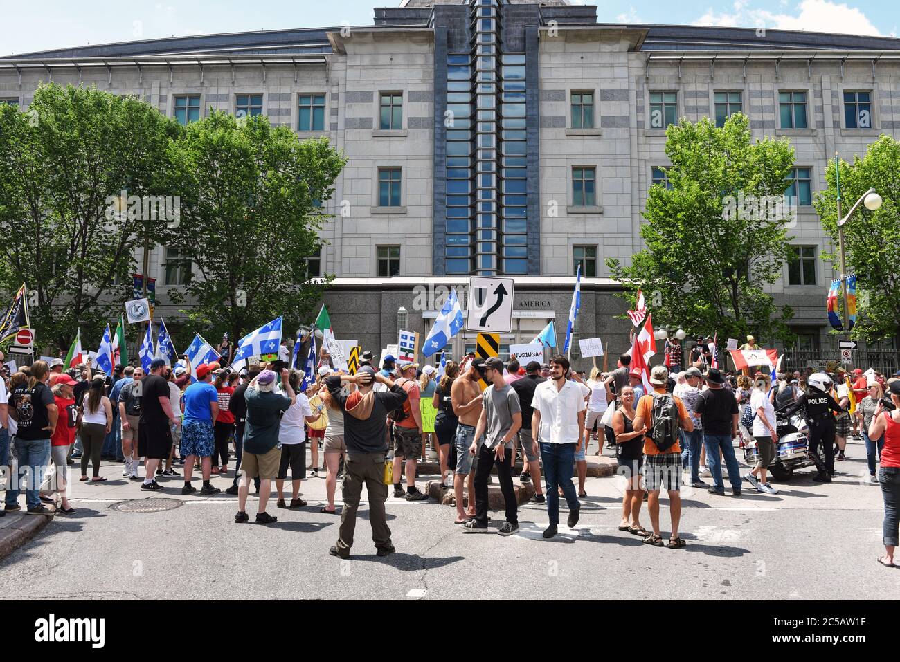 Ottawa, Canada - July 1, 2020: Protesters and counter protesters gather in front of the US Embassy. The annual Canada Day festivities were cancelled due to the Covid-19 pandemic. Stock Photo