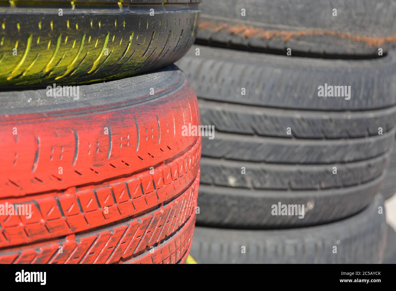 Tires. Red car tires vertically stacked / piled up. Good background for business card for the tire business. Picture for tire business card. Stock Photo