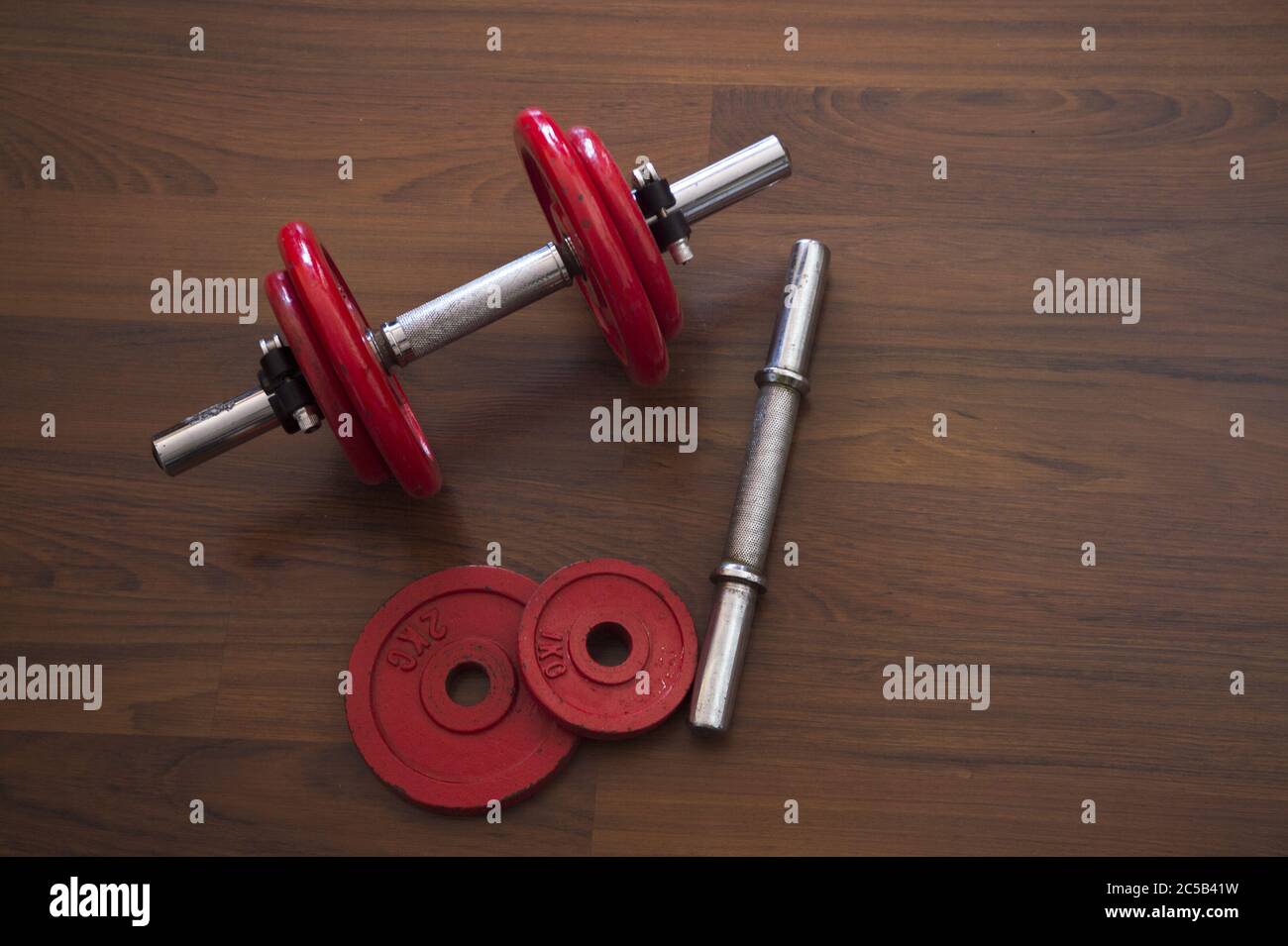 High angle shot of dumbbells on a wooden surface Stock Photo