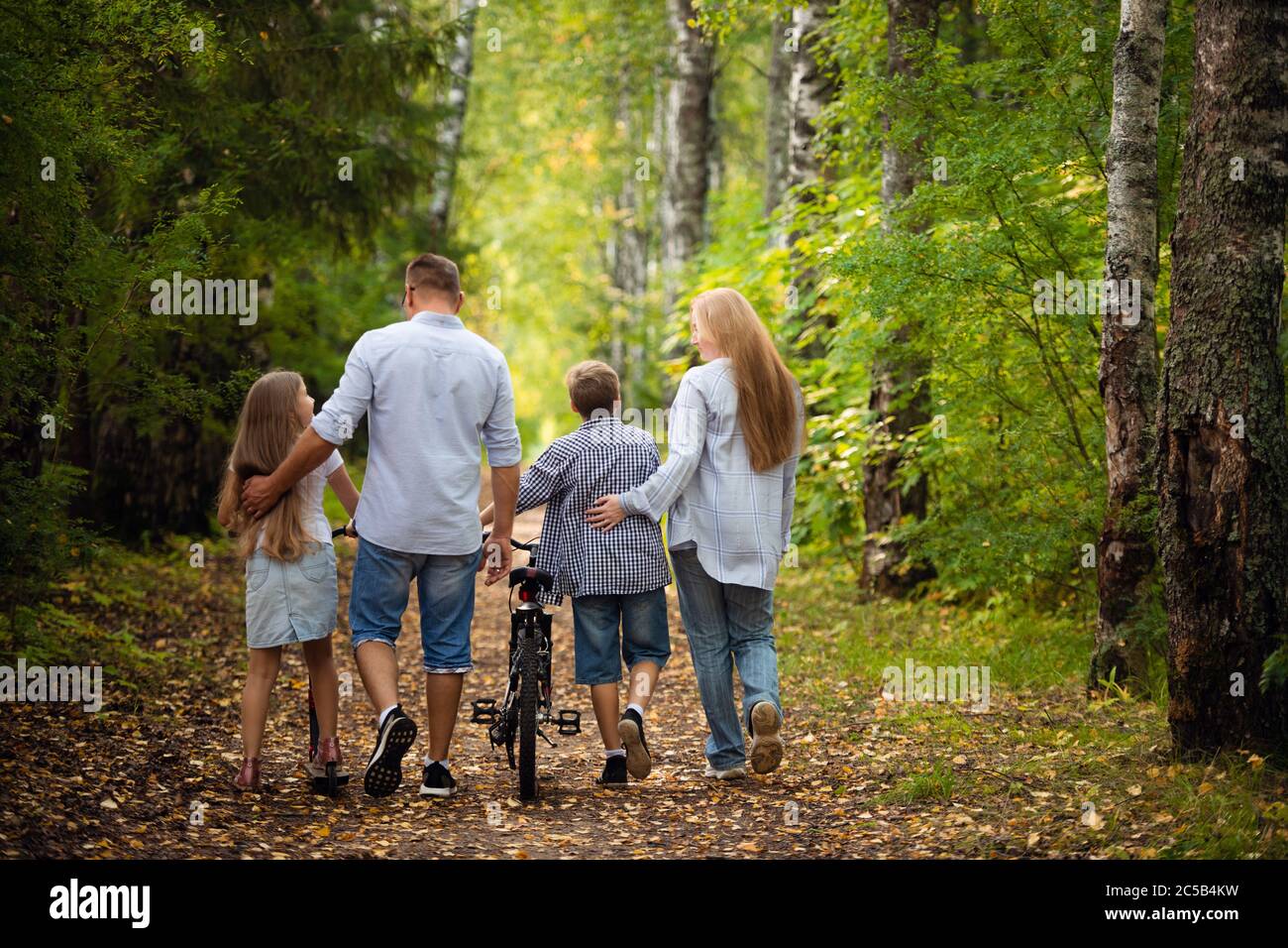 Happy family outdoors smiling in a summer forest Stock Photo