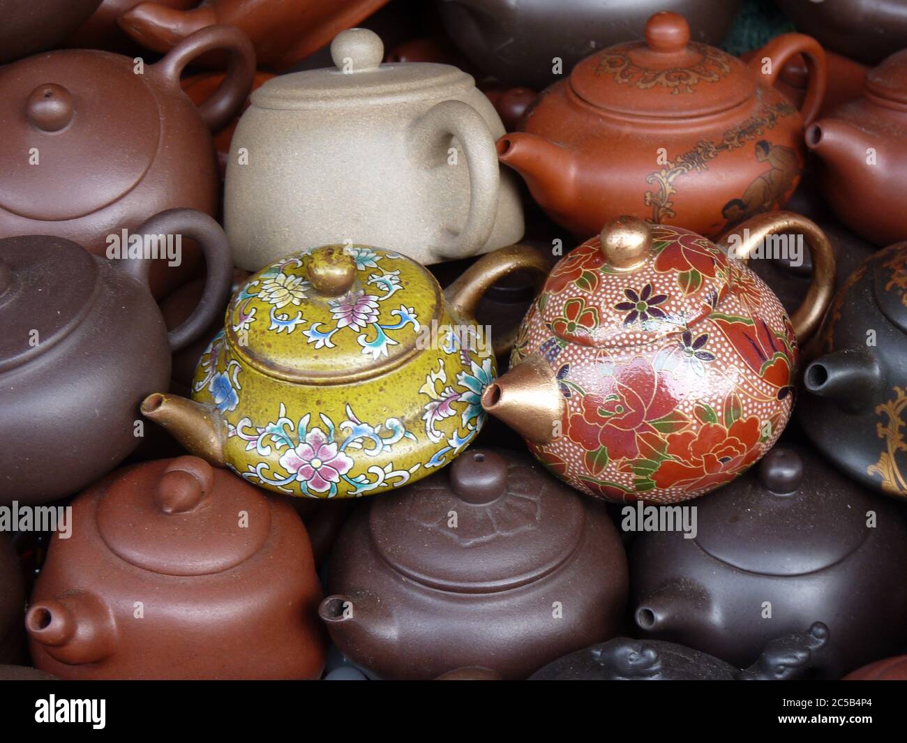 Horizontal shot of beautiful little teapots with ornaments Stock Photo