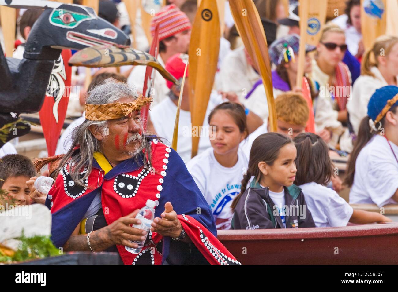 Indigenous tribal members arriving by canoe to attend a major cultural