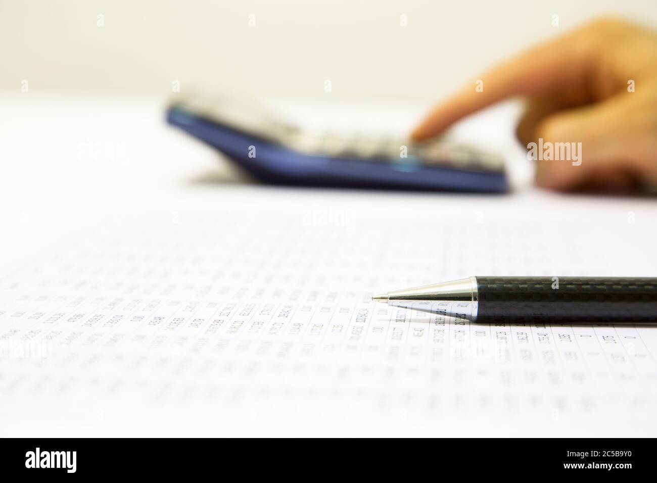 Businessman calculating expense at desk in office Stock Photo Alamy