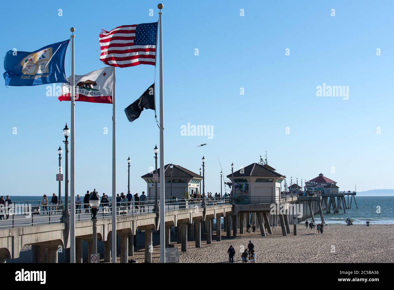 Huntington Beach, CA/USA - Marchh 14, 2019: Tourists enjoying the Huntington Beach Pier on a sunny beautiful spring day Stock Photo