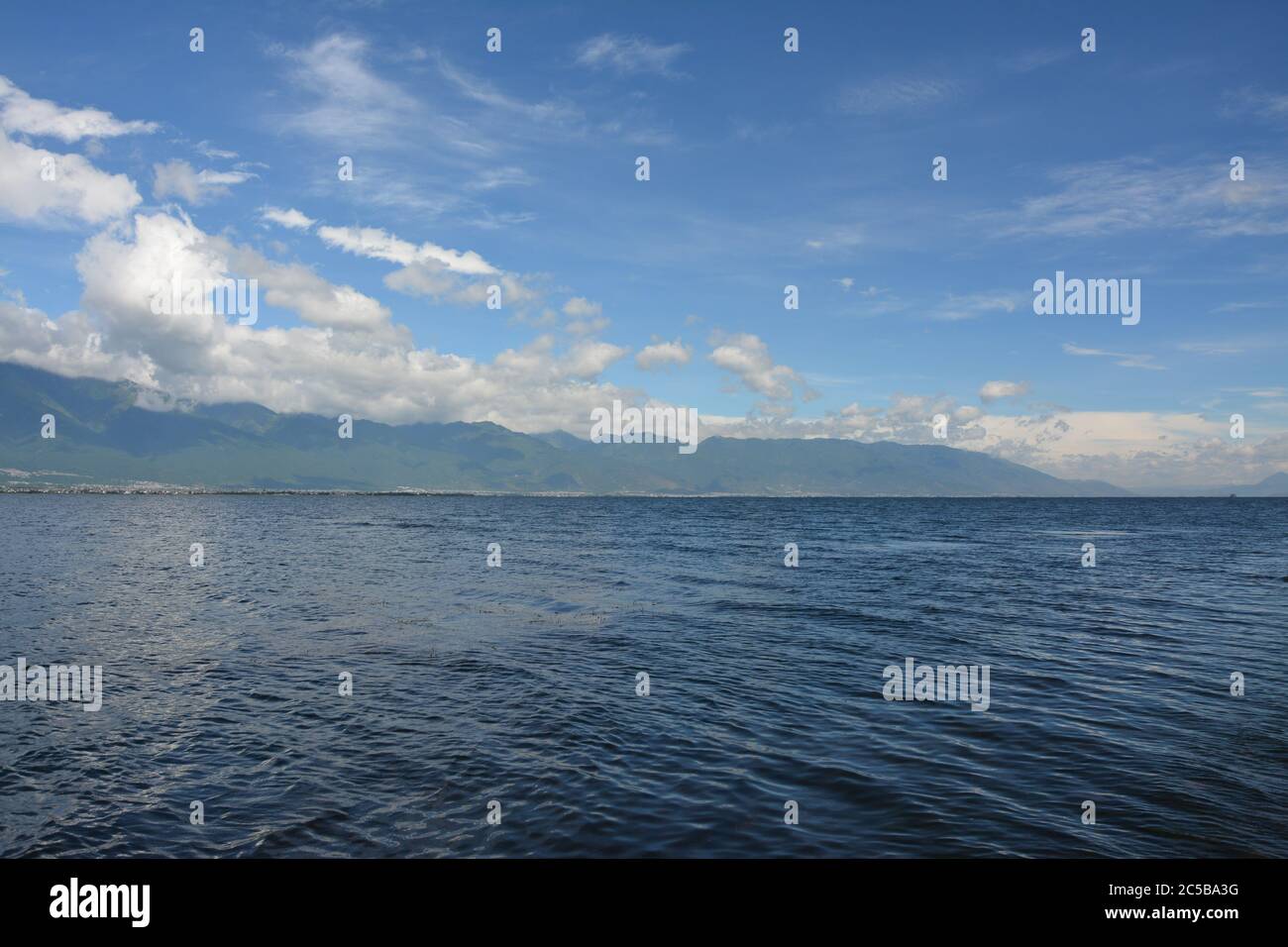 blue lake under the blue sky with white clouds Stock Photo - Alamy