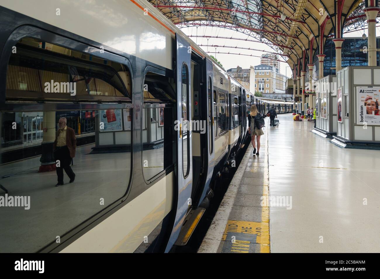 Passengers at the platform and trains at London Victoria Station Stock Photo